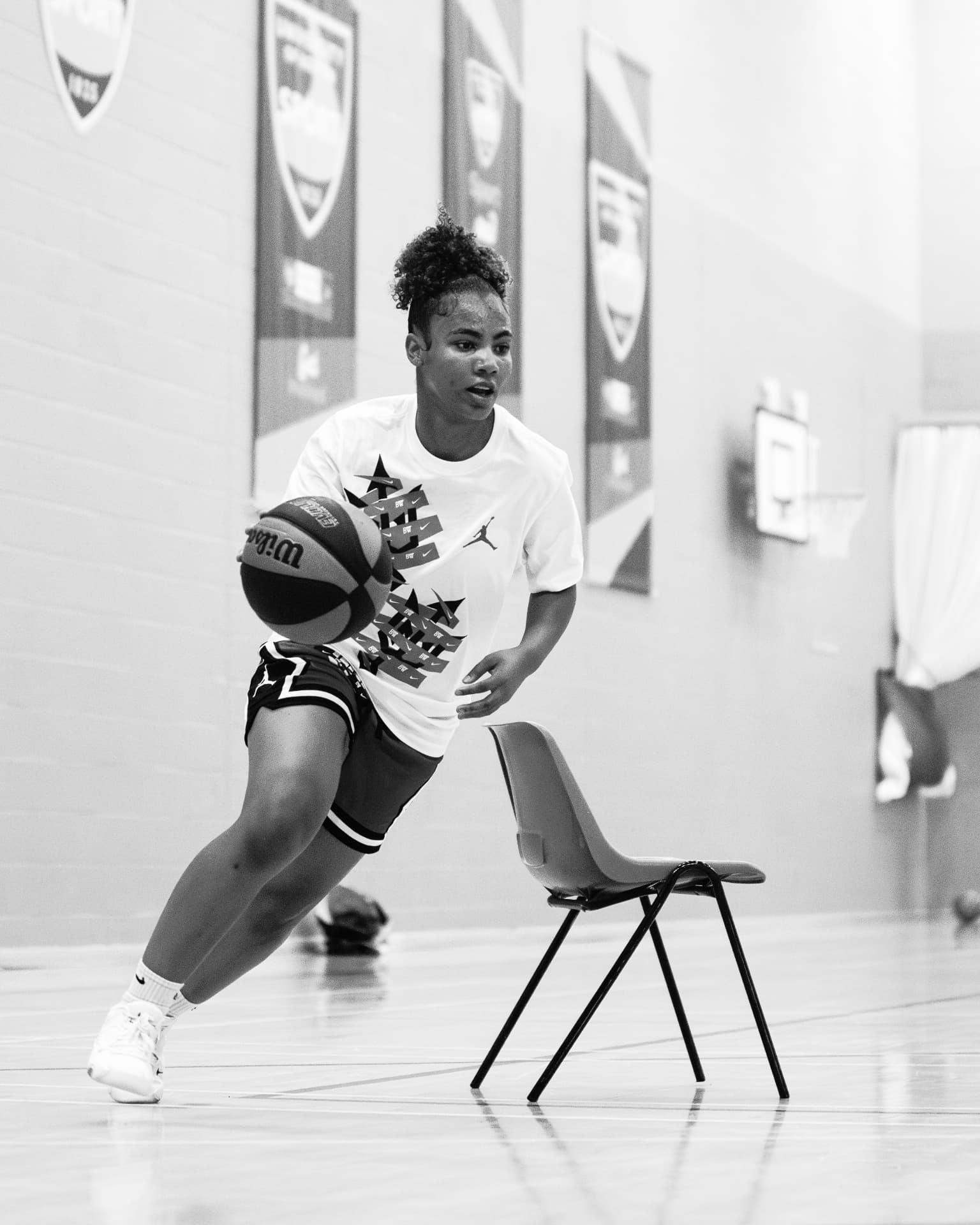 A participant driving with the ball during a drill at the 2025 Workout