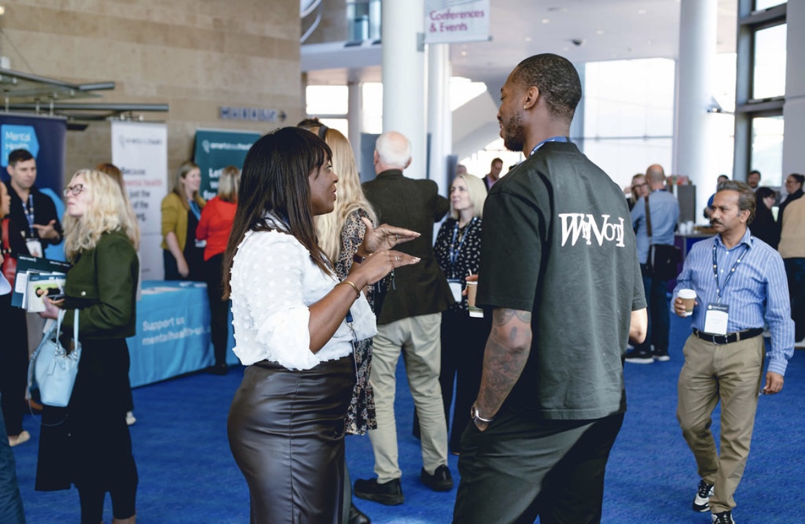 Kofi Josephs in conversation with a corporate professional following the summit session