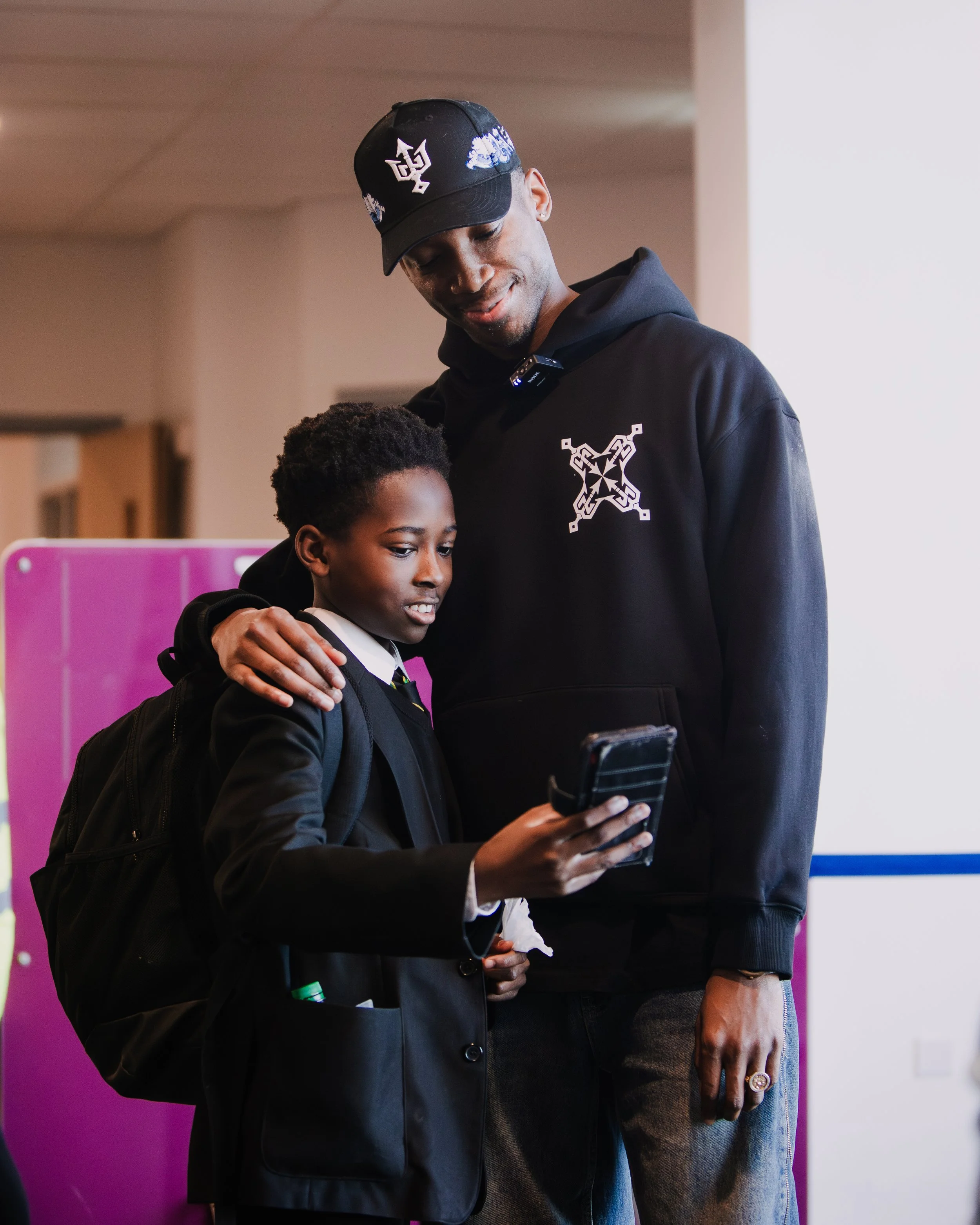 Kofi Josephs sharing a conversation with a student during the school engagement