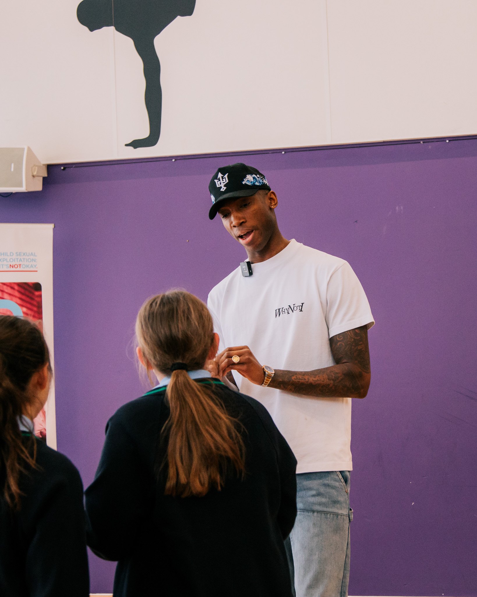 Kofi Josephs in conversation with a young person during the Wigan Youth Zone engagement