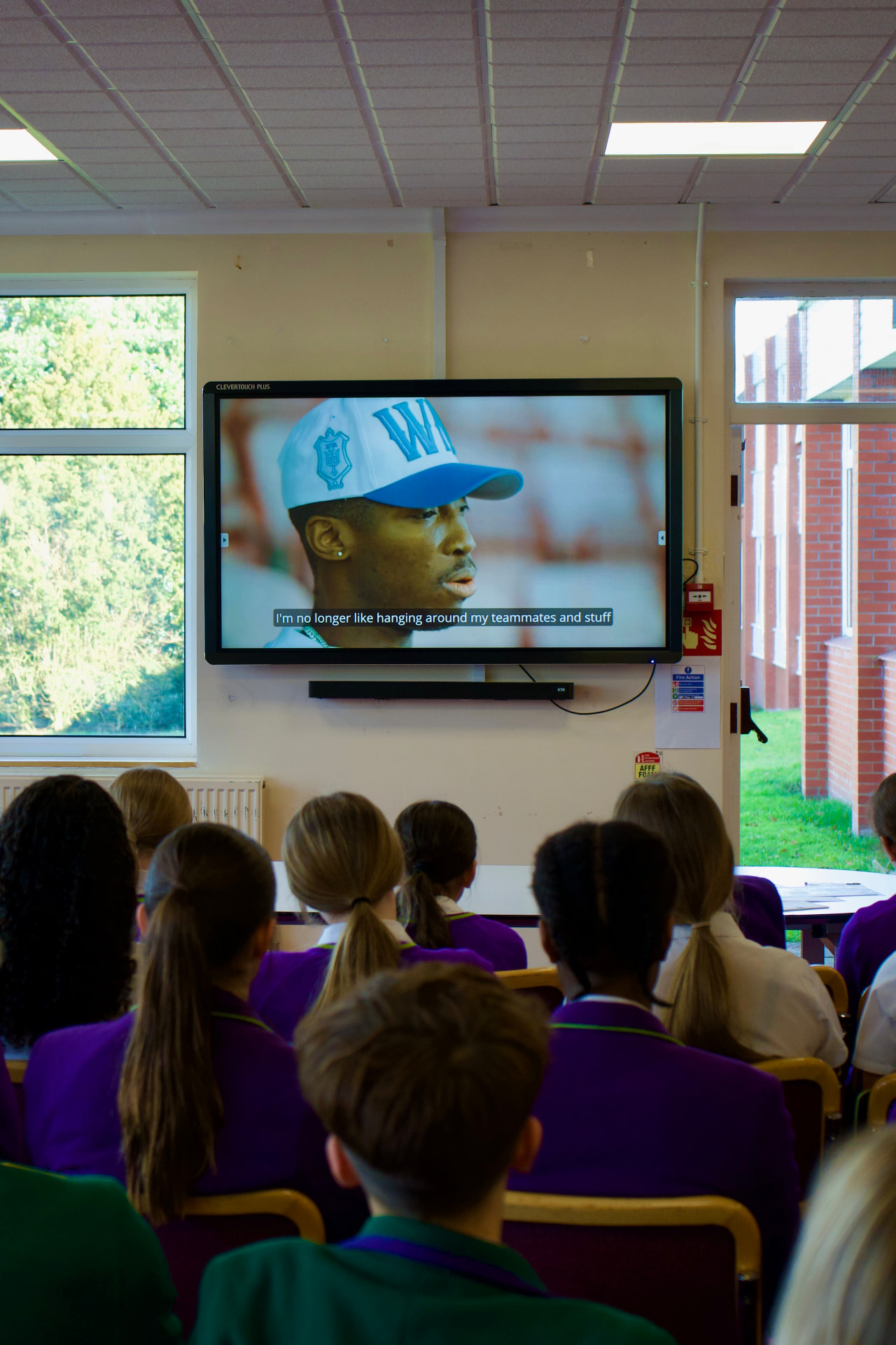 Westholme pupils watching a film of Kofi Josephs in their classroom