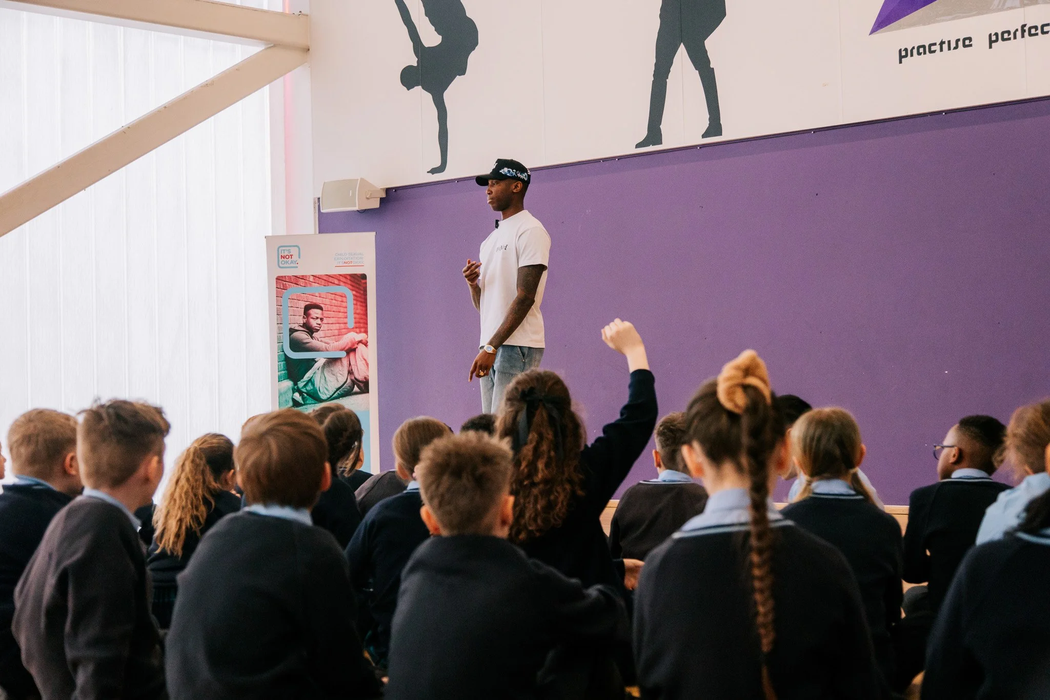 Young people taking part in a group conversation with Kofi Josephs at Wigan Youth Zone