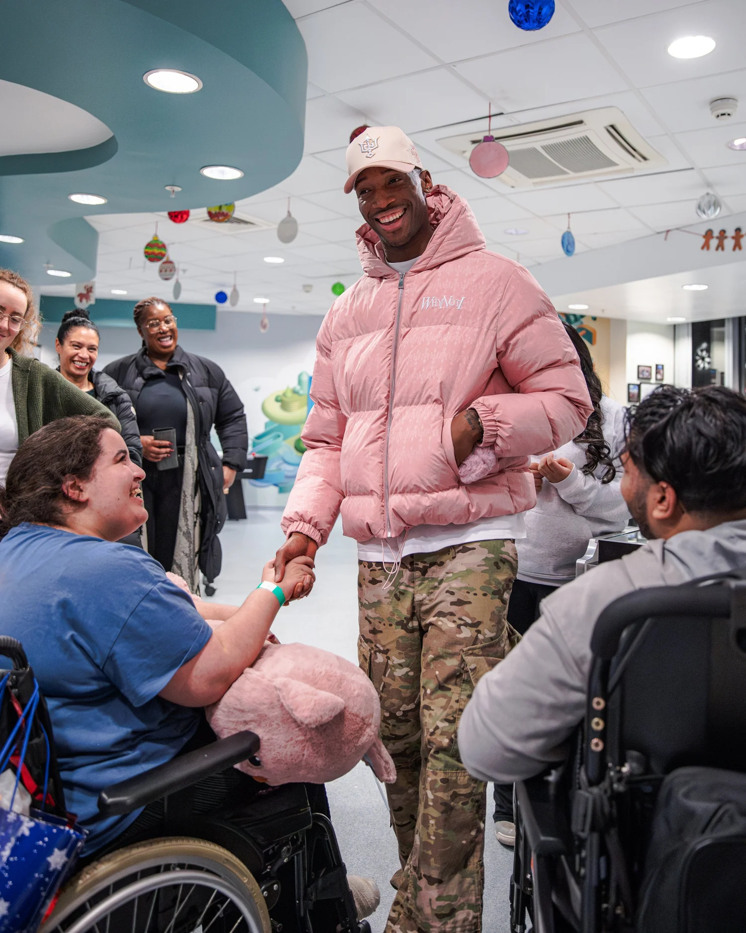 A Why Not I team member greeting a young person during the hospital activation