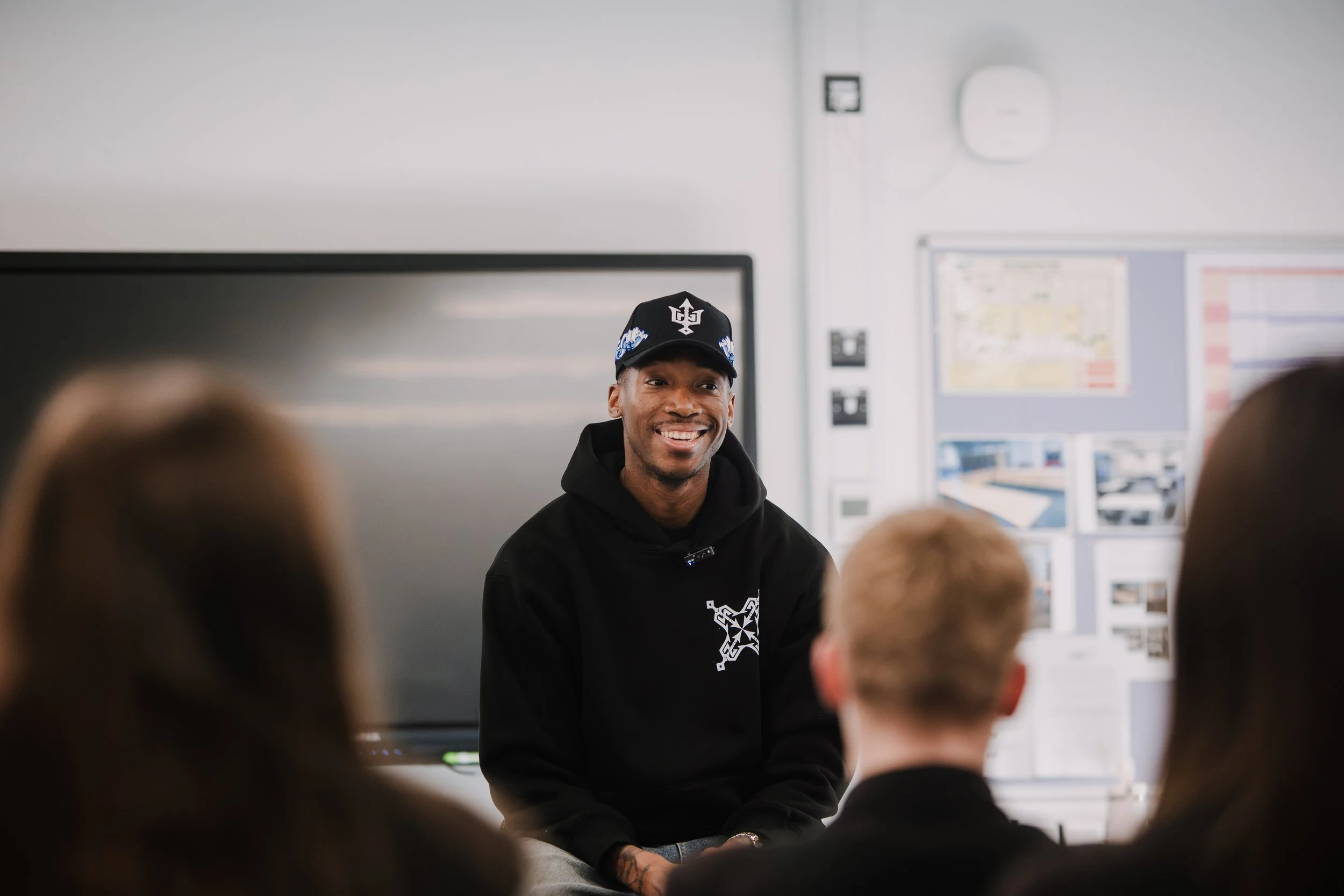 Kofi Josephs speaking with students during a focused classroom discussion
