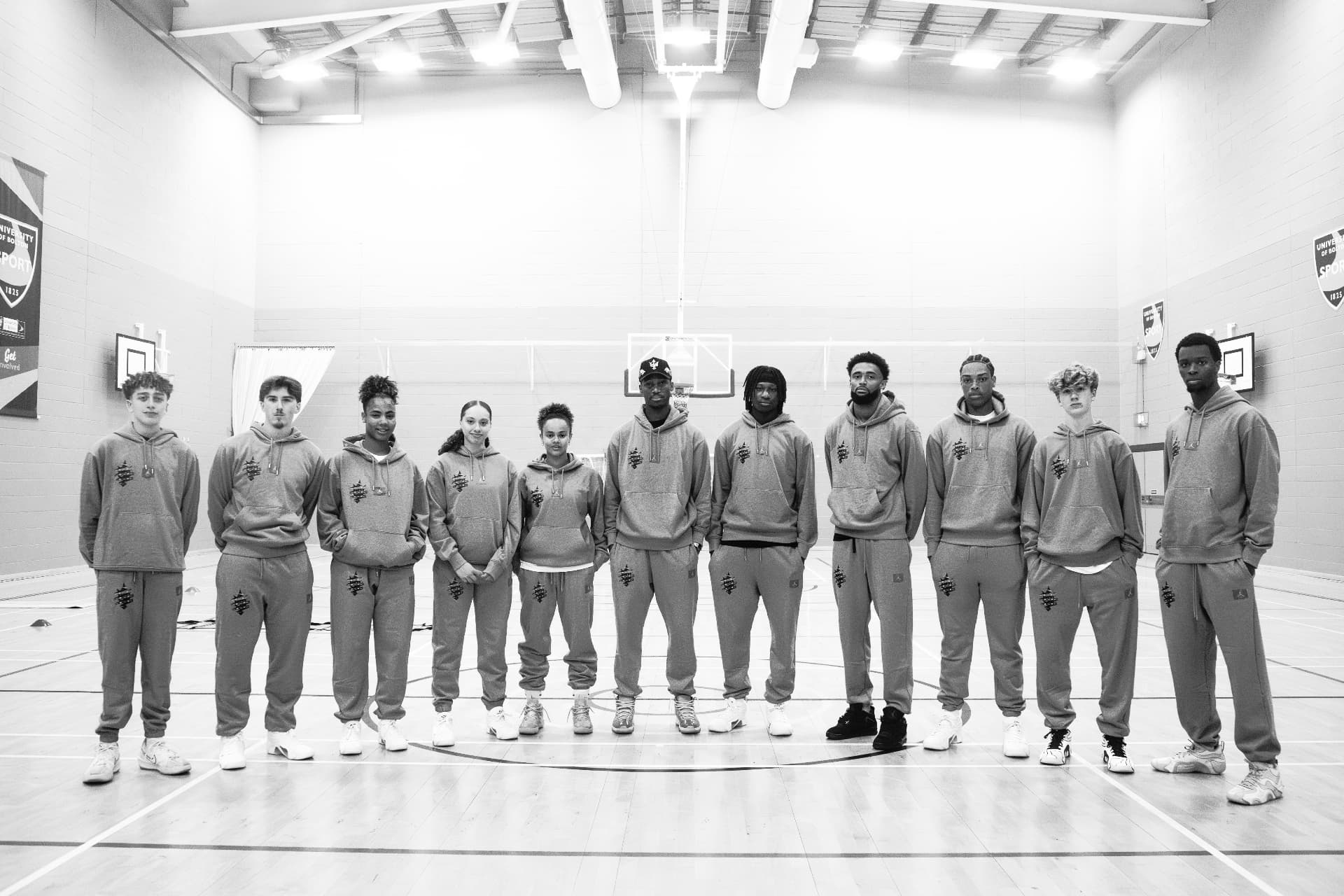 The Why Not I Workouts group standing together on an indoor basketball court