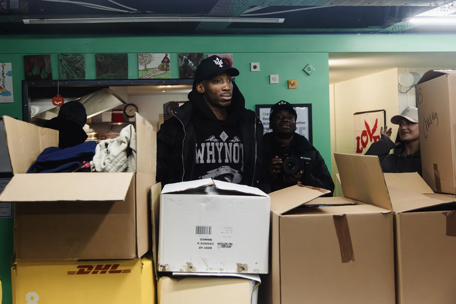 Why Not I team members preparing boxes of donated resources