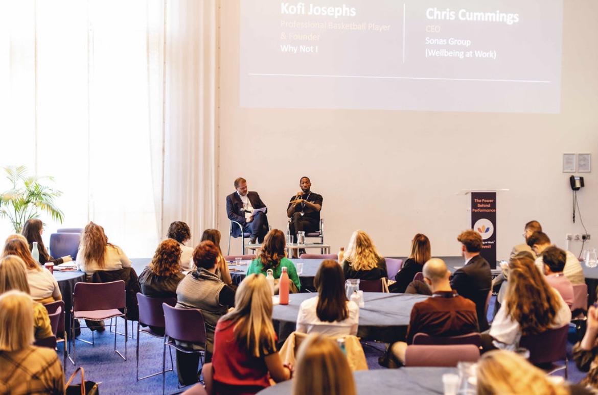 Kofi Josephs sharing his lived experience in conversation with Chris Cummings before a workplace audience