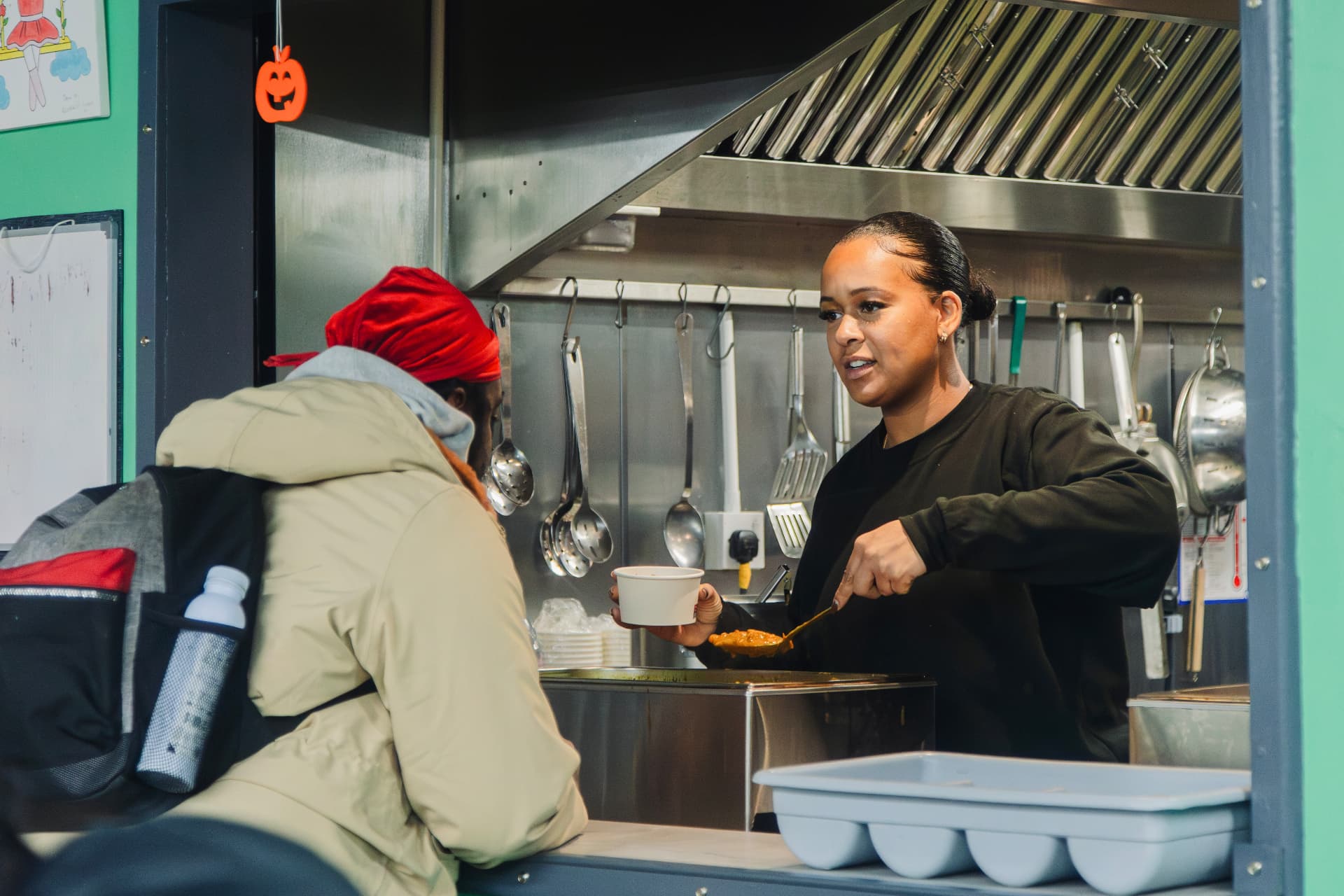 A hot meal being served to someone at the serving hatch during the Coffee 4 Craig activation